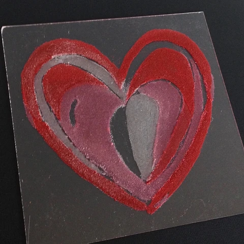 red and pink colored sand heart painting